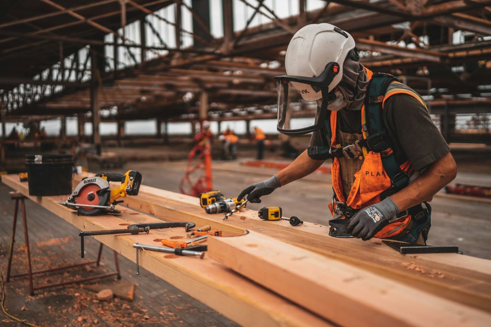 Construction worker using cordless drill on site