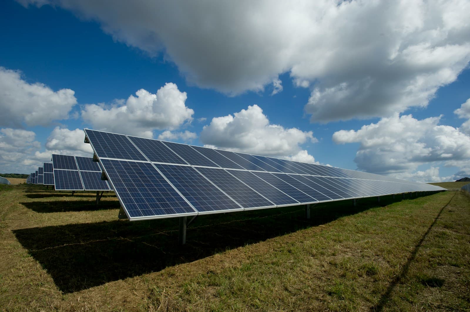 Net-Metering kWh meter and solar panels on Thai factory rooftop
