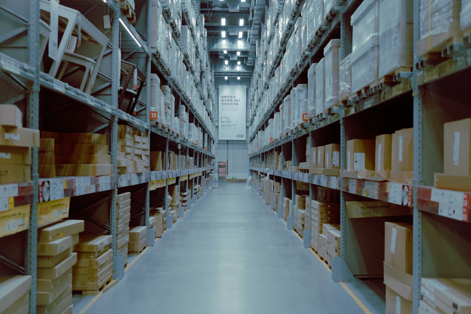 Warehouse aisles showing three pallet racking system types — Selective with aisle between every row, Drive-In with forklift entering the lane, Push-Back with pallets on rolling carts