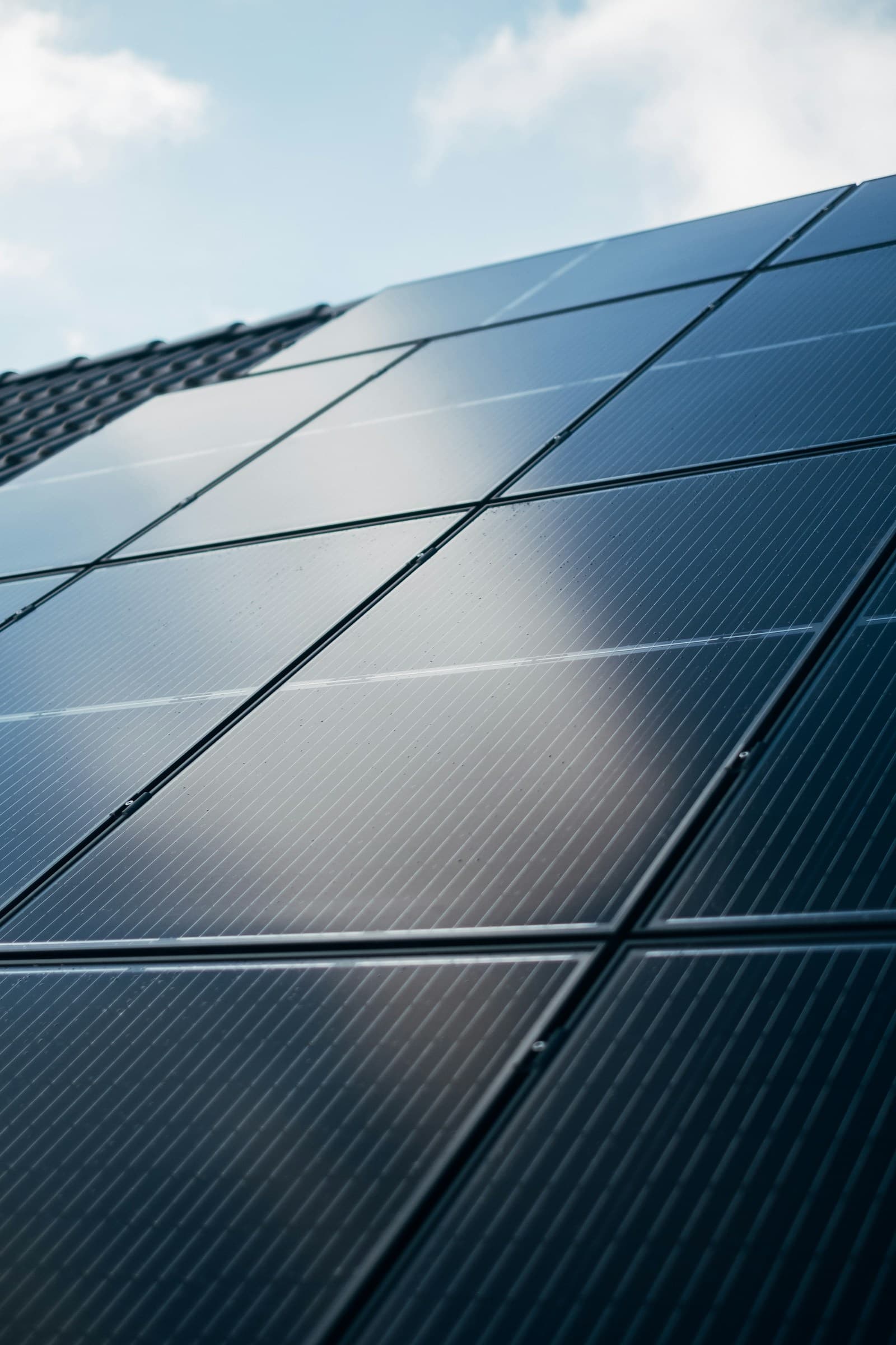 Comparison of string inverter, central inverter, microinverter and power optimizer on a factory solar roof