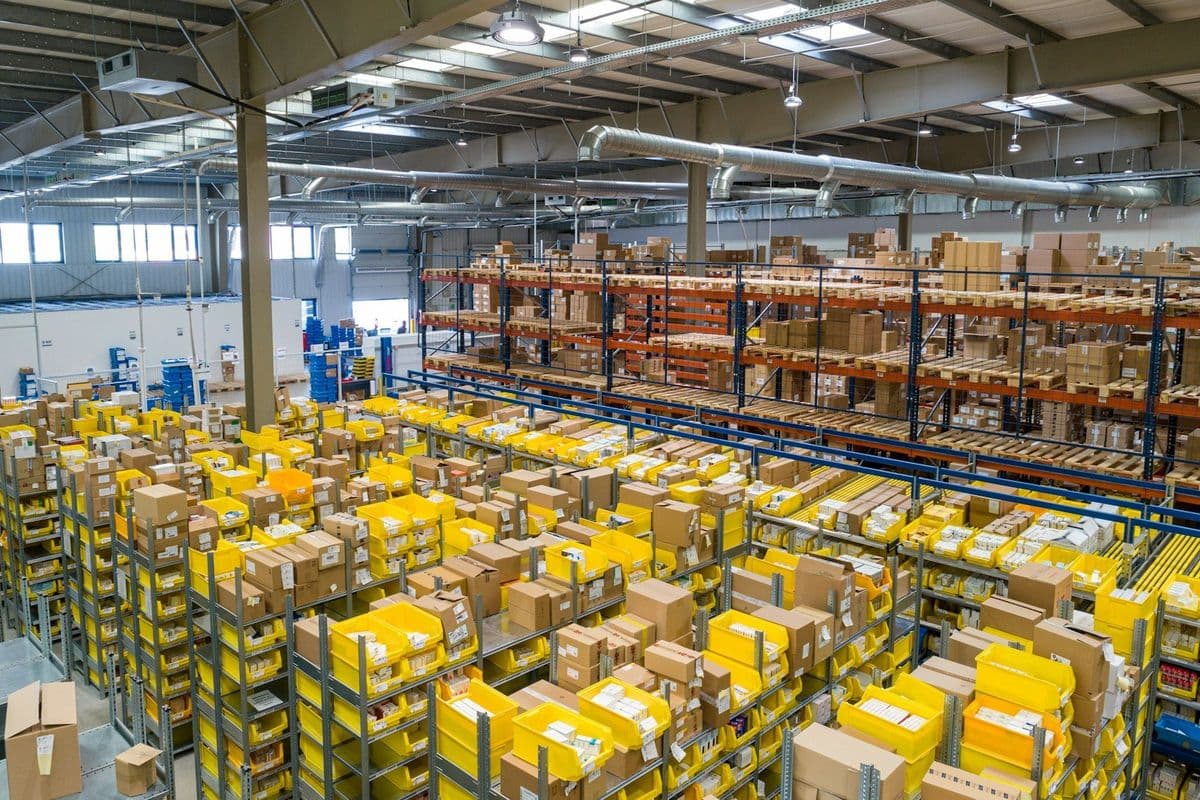 Industrial pallet racking in a large warehouse with forklift aisle access